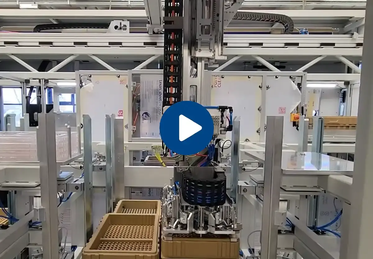 Video preview of an automated handling and assembly system by AWM Arnstadt featuring a linear gantry, cable carrier, and component trays.