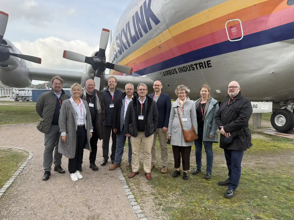 Group of the IGF Expert Committee 3 standing in front of a historic Super Guppy aircraft at Airbus Hamburg