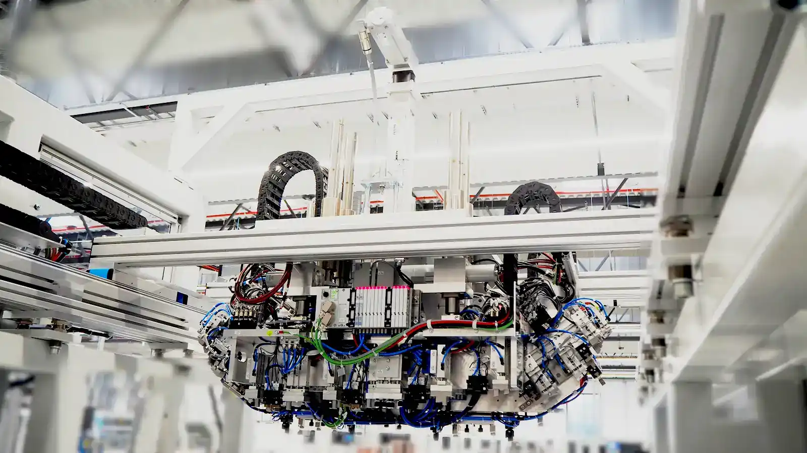 View of an overhead-installed handling system with pneumatic cabling and control units for automated manufacturing processes in custom machine building at AWM Arnstadt.